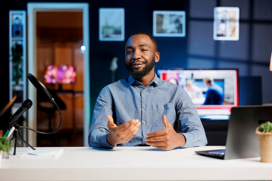 African american content creator doing story time type of video for subscribers, filming in personal home studio. Internet show host telling viewers about interesting events, keeping audience engaged