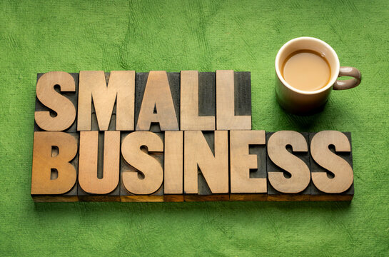 small business - word abstract in vintage letterpress wood type, flat lay with coffee