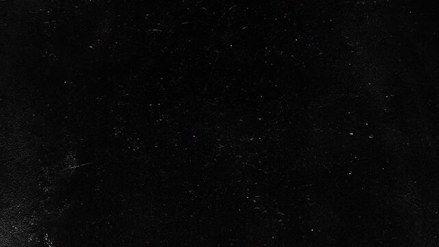 Dark Dusty Grunge Background with Subtle Film Grain, Distressed Black Texture and Cinematic Motion Graphics Animation Loop