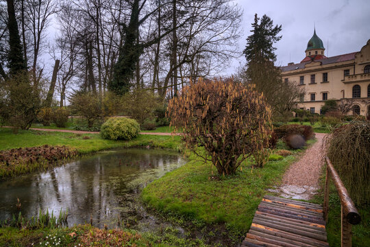 Průhonice Castle park with pond and wooden bridge