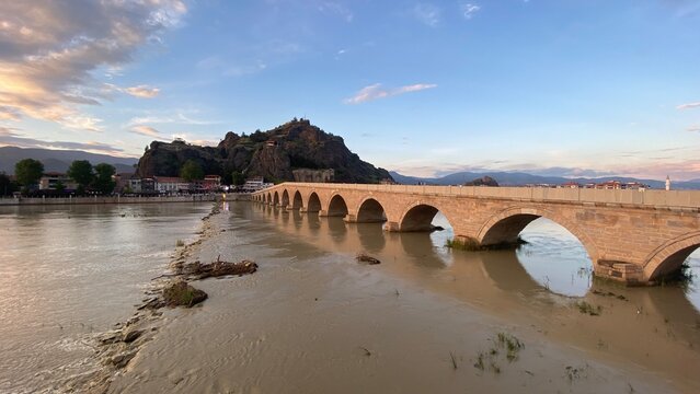 Historic Koyunbaba Bridge spanning the Kızılırmak River in Osmancık, &Ccedil;orum, T&uuml;rkiye. This magnificent 15th-century Ottoman stone arch bridge, built during the reign of Sultan Bayezid II, stands as one