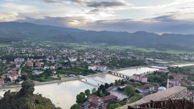 Panoramic view from Osmancık Castle overlooking the historic Koyunbaba Bridge, the winding Kızılırmak River, and the town of Osmancık in &Ccedil;orum, T&uuml;rkiye. This breathtaking landscape combines centuries 
