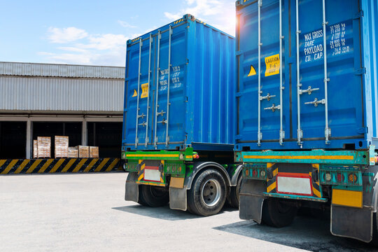 Semi Trailer Trucks on the parking lot at Warehouse. Freight Transportation Logistics Truck. Shipping Cargo Container. Trucks Loading Goods at Dock Warehouse. Distribution Warehouse.