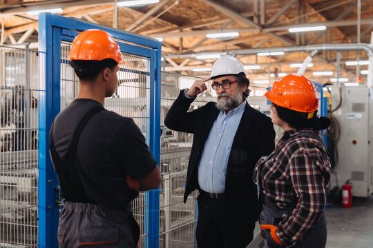 Factory workers and manager discussing production plans