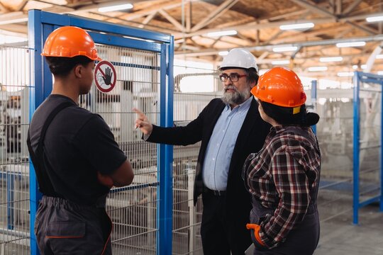 Supervisor instructing workers in window factory safety