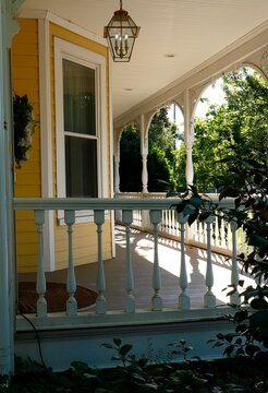 Yellow siding and wrap around porch
