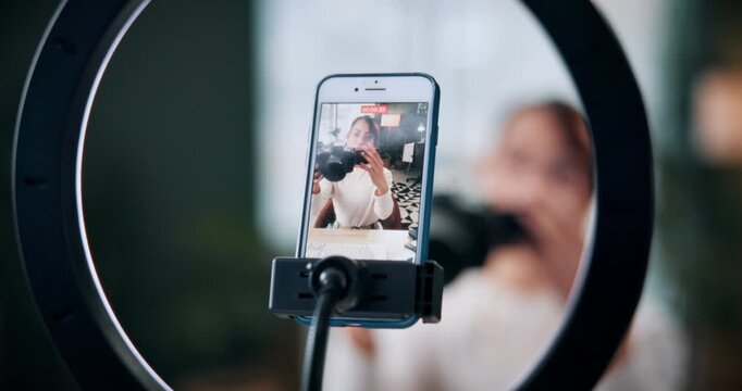 Woman, photographer and vlogger with phone screen for live recording or online tutorial in home. Female person, freelancer or content creator with smartphone or ring light for advice, help or tips