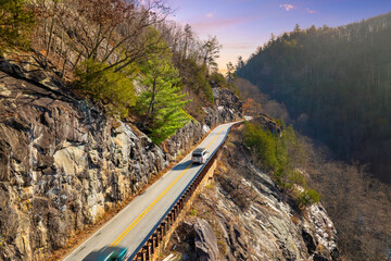 Fototapeta premium Winding Highlands Road offers a beautiful mountain pass experience in peak fall season.