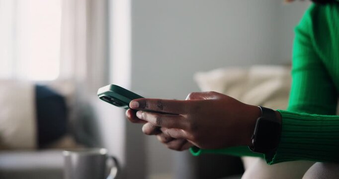 Close Up of African American Hands Using a Smartphone and Smartwatch Indoors