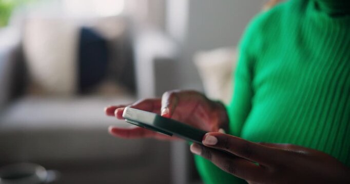 Close Up of African American Hands Scrolling and Typing on a Modern Smartphone