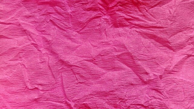 Textured vibrant hot pink tissue paper background. Wrinkled corrugated panoramic texture for bridal shower decor. Abstract creased rose pink creped paper surface. Detailed crushed paper texture.