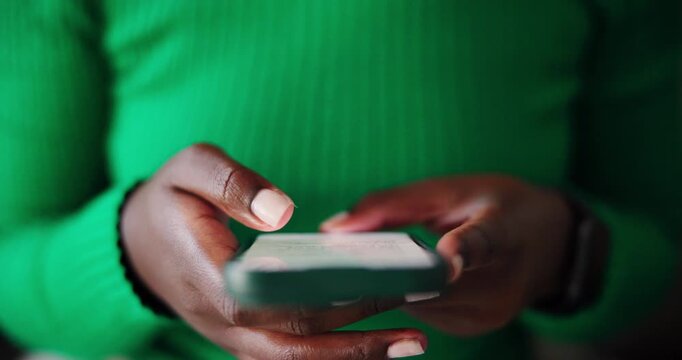 Close-Up of African American Hands Typing and Interacting with a Smartphone Screen