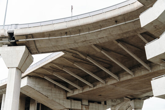 Massive concrete overpass viewed from below showing engineering details. Infrastructure and construction concept.