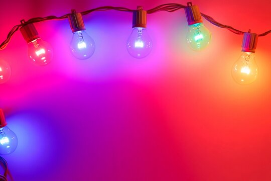 Color-changing LED bulbs pulsing rhythmically against a vibrant backdrop at a festive gathering