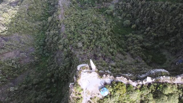 Drone aerial view Mountain piedra colgada, Colombia Latin America, tree zone forest nature area, blue sky, 4k