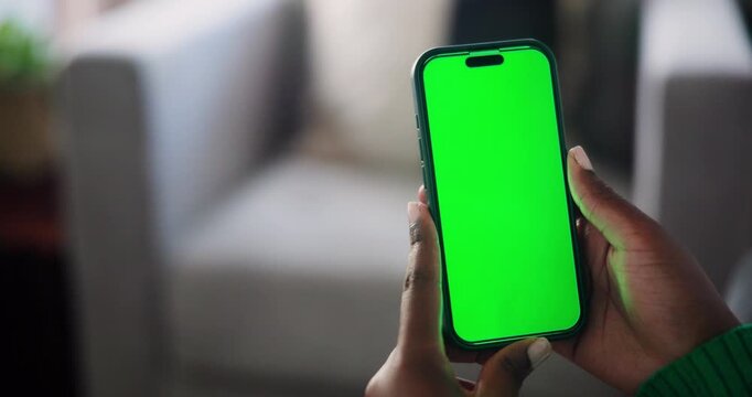Close-Up of African American Hands Holding a Modern Smartphone with a Green Screen Display for Custom Content