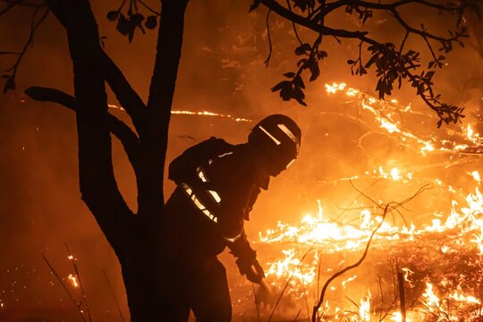 Night Wildland Firefighters Conducting Direct Attack on Active Grassfire Front