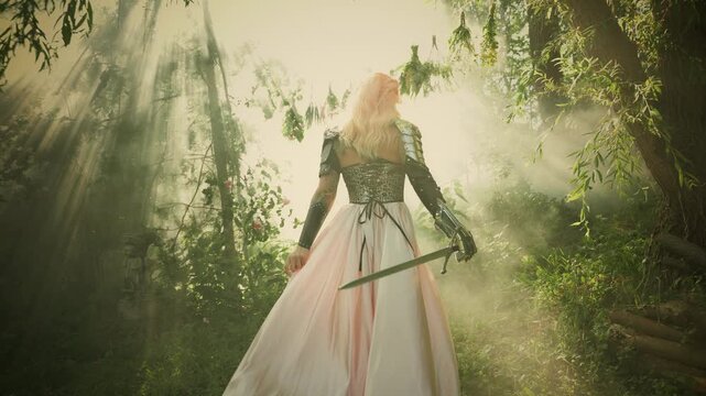 Fantasy style woman knight in metal iron armor beauty dress elf girl blonde hair back rear view. Silhouette fairy queen warrior holding sword walking in green forest trees magic sun light fog smoke 4k