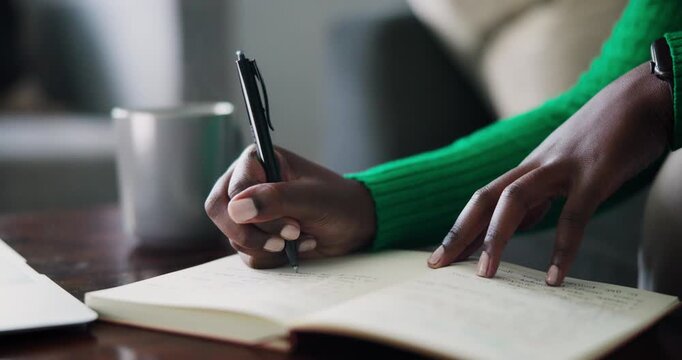 Close-Up of Focused African American Hands Writing in a Notebook, Highlighting Productivity and Planning