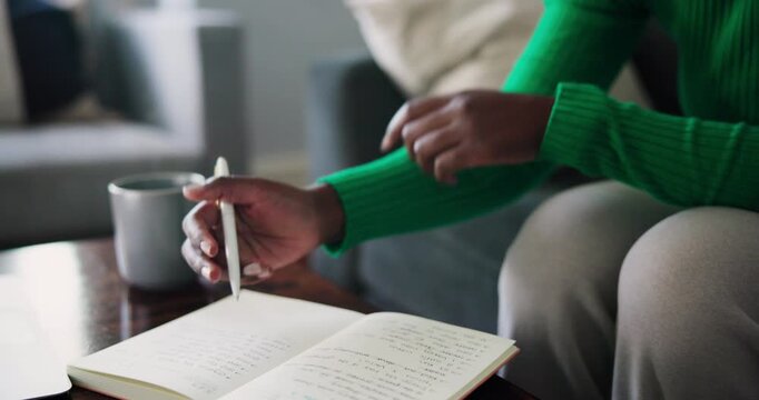 Black Woman's Hands Writing in a Journal with a Pen while Reflecting at Home