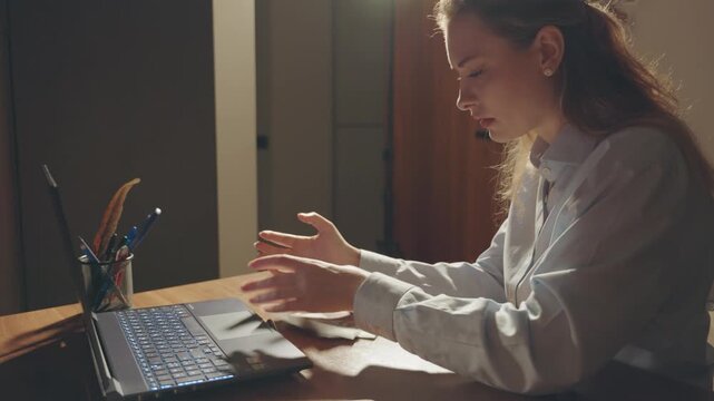 Sad face girl in stress anxiety lack of money upset tired woman working on laptop overloaded with work, sitting at desk in office overtime job. Person counting money few dollars bills, small salary.