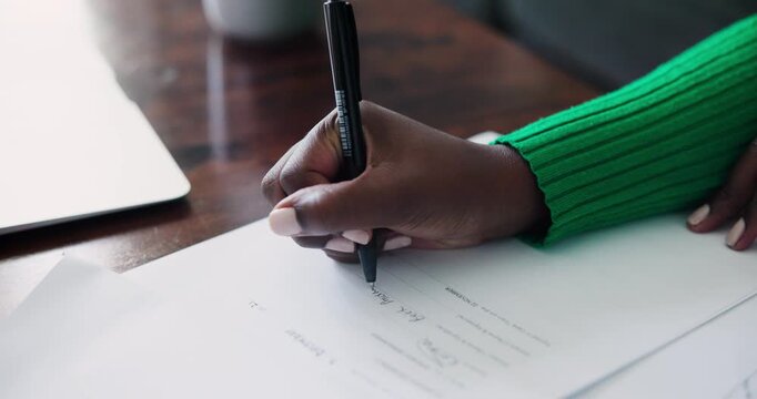 Professional African American Hand Signing Important Document on a Wooden Desk