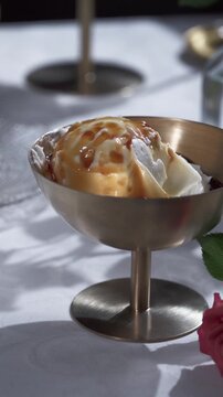 Eating Ice Cream with Caramel in a Brassy Cup