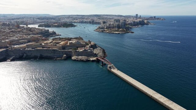 Aerial view of Fort Saint Elmo and the historic breakwater at the entrance of Grand Harbour under a clear sky in Valletta, Port Region, Malta.