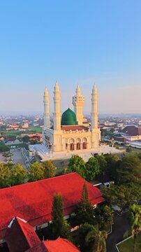 Drone View of Grand Mosque with Green Dome and Four Minarets at Sunset in Indonesia