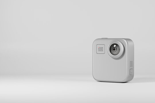 Compact action camera on gray background with copy space