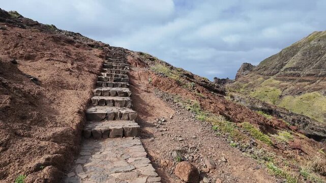Slow forward walking shot up steep stone stairs on PR8 hiking trail in Madeira
