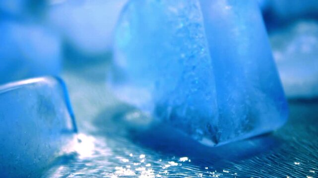 Frozen blue ice cubes with water droplets, macro shot of melting ice blocks, refreshing cold texture for beverage and summer cooling concepts