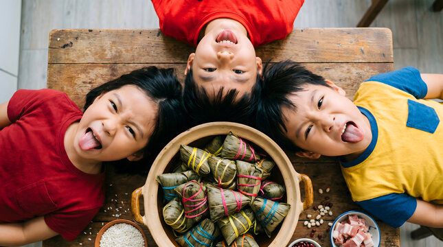 Three children making zongzi around a wooden table for the Dragon Boat Festival