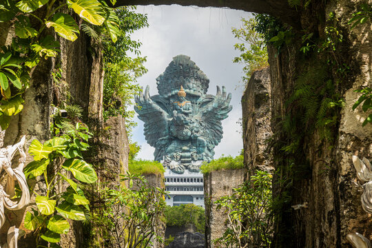 Garuda Wisnu Kencana Monument Framed by Tropical Stone Corridor in Bali Indonesia