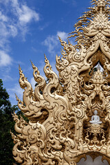 Fototapeta premium Close-up of golden ornament and Buddha figure at Wat Rong Khun, Thailand