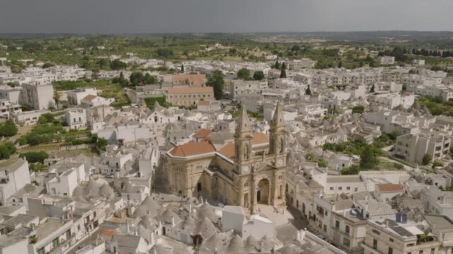 Aerial views of Alberobello&rsquo;s iconic trulli rooftops, winding streets, and sunlit limestone houses, capturing the charm and symmetry of this UNESCO-listed Italian village.