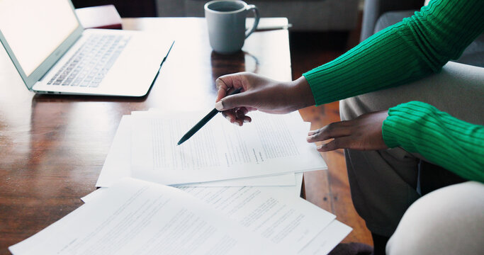 Businessperson Reviewing Documents at Home Office Desk With Laptop and Coffee Stock Photo