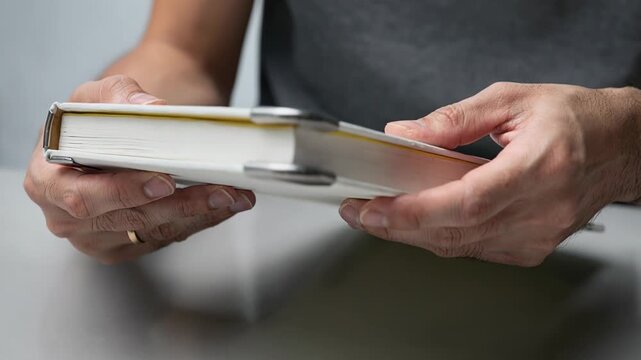 Medium shot focusing on rounded metal protectors being installed on a blankbook corner showcasing smooth finishes and added safety for frequent use