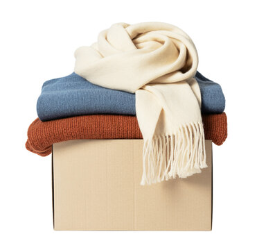 stack of sweaters and scarf on cardboard box isolated on a transparent background.
