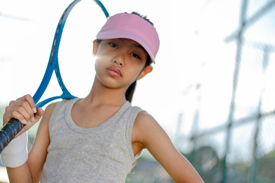 A girl is on the tennis court to play tennis.