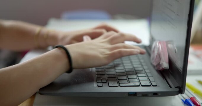 Focused on the Digital Frontier: Close-up on a person's hands typing diligently on a laptop, showcasing a moment of concentration and productivity in the modern digital age.