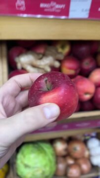 Produce Market Cinematic - Comparing Red Apples and Taking One to Scale POV