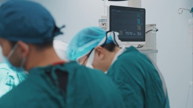 Medical surgeons working during a surgical procedure in a modern operating room. Surgery, teamwork, hospital care, healthcare technology, emergency medicine, patient safety and professional medical pr
