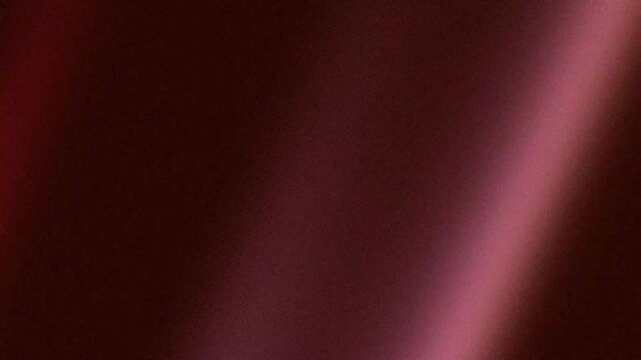 Retro diagonal pink light flare glowing over dark brown textured background with cinematic analog film grain