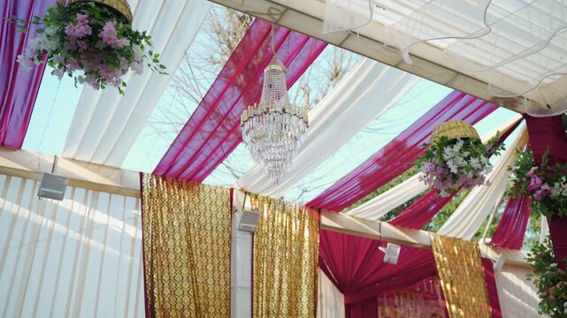 Cinematic Panning Shot of Elegant Chandelier and Floral Wedding Decorations