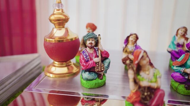 Panning Shot of Traditional Indian Folk Musician Figurines and Wedding Decor