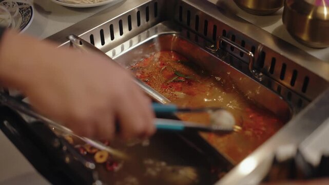 Adding Ingredients to Divided Hot Pot