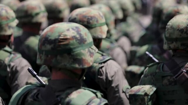 Rear View of Army Soldiers in Camouflage Uniforms Marching in Formation