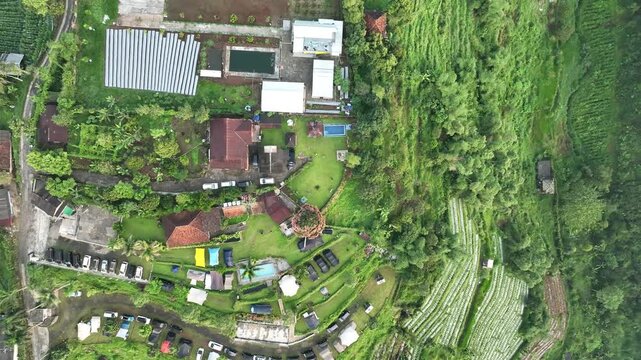 Aerial view of Joglo Java Neglasari resort featuring swimming pools, parking areas, and lush tropical greenery in Cigombong, West Java, Indonesia.