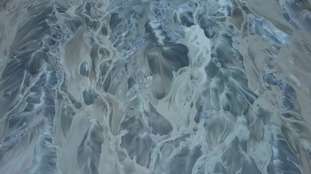 Terrestrial Canadian landscape of glacial like river melt water mixed with natural mineral sediment rare earth mining site. Stunning abstract pattern human made geological formation. Surreal landscape